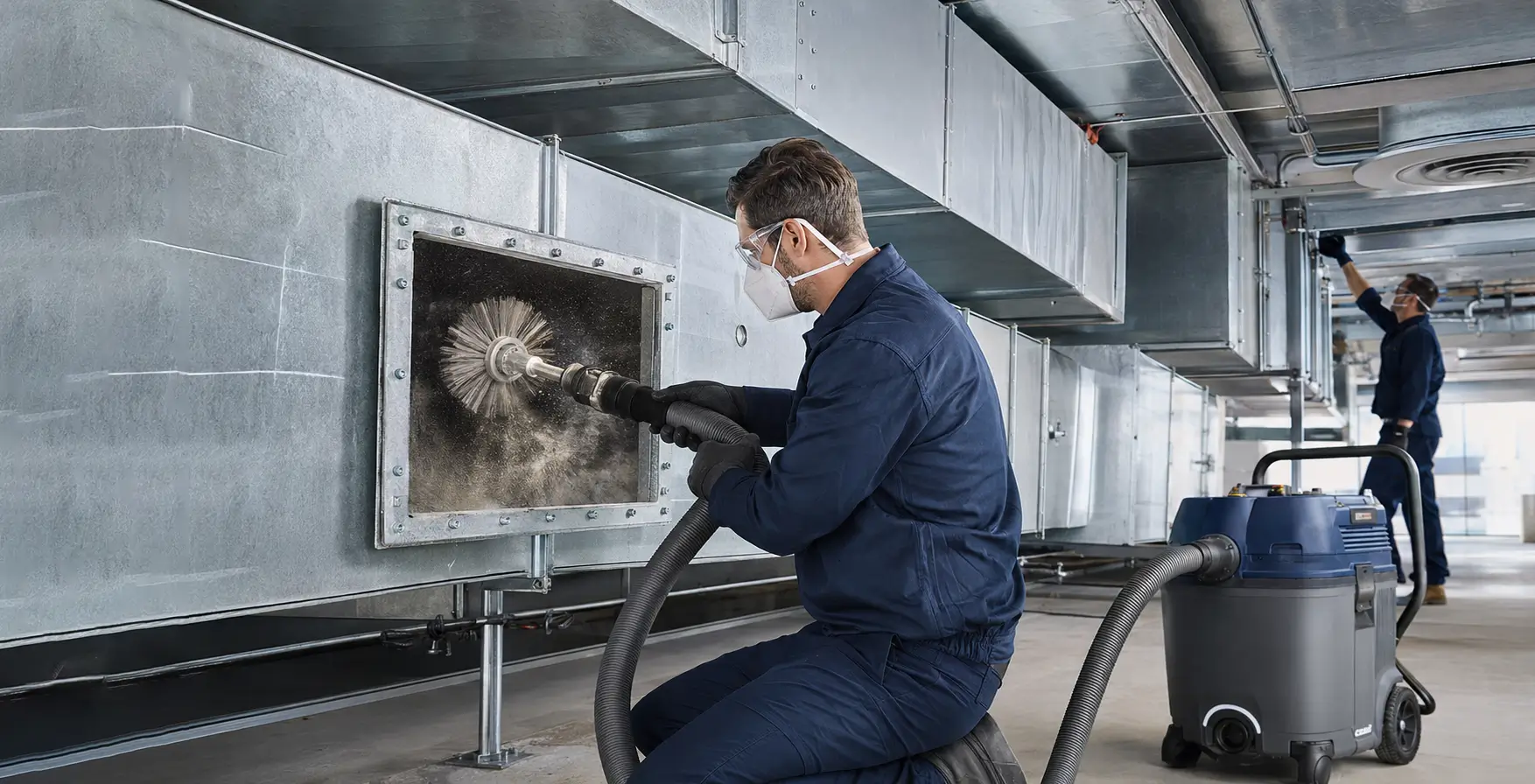 Professional technicians cleaning a commercial ventilation duct system